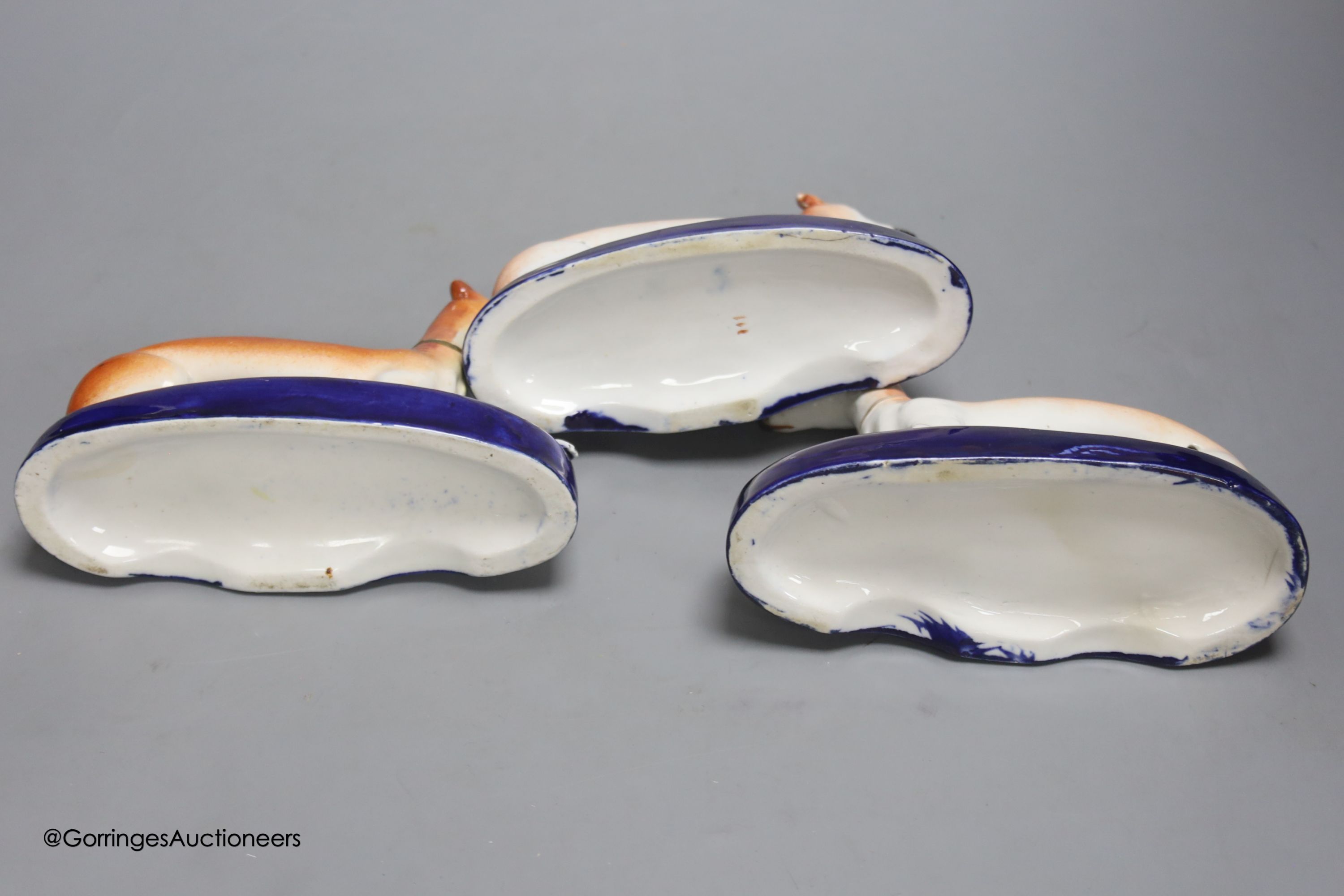 A pair of Staffordshire greyhounds and another similar, tallest 12cm